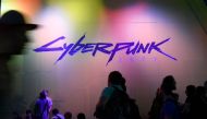 In this file photo taken on August 21, 2019 visitors wait at the Cyberpunk 2077 stand during the Video games trade fair Gamescom in Cologne, western Germany. Sony said on December 18, 2020 it was pulling the much-hyped Cyberpunk 2077 from PlayStation stor