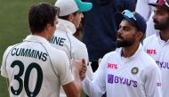 India's Virat Kohli (R) congratulates Australia's Pat Cummins (L) on the third day of the first cricket Test match between Australia and India in Adelaide on December 19, 2020. AFP / William West  