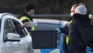 Officials collect Coronavirus COVID-19 testing samples at a drive-through test centre amid the spread of the coronavirus disease (COVID-19) in London, Britain, December 19, 2020. REUTERS/Toby Melville