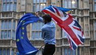 In this file photo taken on June 28, 2016 a man waves both a Union flag and a European flag together on College Green outside The Houses of Parliament at an anti-Brexit protest in central London. (AFP / JUSTIN TALLIS)