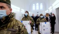 Hungarian soldiers carry the first shipment of Pfizer-BioNTech coronavirus disease (COVID-19) vaccines at the Del-Pest Central Hospital in Budapest, Hungary, December 26, 2020. Szilard Koszticsak/Pool via REUTERS
