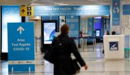 A person walks near of a COVID-19 test area at Fiumicino airport after the Italian government announced flights to and from the UK will be resumed following an order by the Health Ministry, amid the spread of the coronavirus disease (COVID-19), in Rome, I