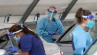 Medical workers administer tests at the Bondi Beach drive-through coronavirus disease (COVID-19) testing centre in the wake of an outbreak in Sydney, Australia, December 22, 2020. REUTERS/Loren Elliott/File Photo