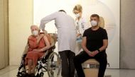 World War II veteran Emilie Repikova sits next to PM Andrej Babis as she receives the second injection nationwide with a dose of Pfizer-BioNTech COVID-19 vaccine at Military University Hospital, as the coronavirus disease (COVID-19) outbreak continues, in