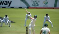 South Africa's Dean Elgar (C) plays a shot during the second day of the first Test cricket match between South Africa and Sri Lanka at SuperSport Park in Centurion on December 27, 2020. / AFP / Christiaan Kotze
