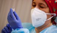 A health worker prepares an injection with a dose of the Pfizer-BioNTech COVID-19 vaccine, as the coronavirus disease (COVID-19) outbreak continues, at Balafia nursing home, in Lleida, Spain, December 27, 2020. REUTERS/Albert Gea

