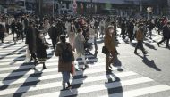 Passersby wearing protective face masks walk on the Shibuya crossing, amid the coronavirus disease (COVID-19) outbreak in Tokyo, Japan, in this photo taken by Kyodo December 26, 2020. Mandatory credit Kyodo/via REUTERS
