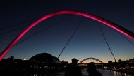 People watch the sunset ahead of the start of tier 4 restrictions as the coronavirus disease (COVID-19) outbreak continues, at Quayside in Newcastle, Britain December 30, 2020. REUTERS/Lee Smith
