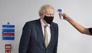 Britain's Prime Minister Boris Johnson has his temperature checked during a visit to Chase Farm Hospital in north London, Britain January 4, 2021. Stefan Rousseau/Pool via REUTERS