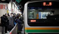 Commuters wearing protective face masks wait to enter a train on the way home, amid the coronavirus disease (COVID-19) outbreak, at a train station in Tokyo, Japan, January 5, 2021. Reuters/Issei Kato