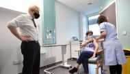 Britain's Prime Minister Boris Johnson looks on as junior sister Susan Cole receives the Oxford University/AstraZeneca COVID-19 vaccine during his visit at the Chase Farm Hospital, in north London, Britain January 4, 2021. Stefan Rousseau/Pool via Reuters