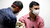 A medic administers COVAXIN, an Indian government-backed experimental COVID-19 vaccine, to a health worker during its trials, at the Gujarat Medical Education & Research Society in Ahmedabad, India, November 26, 2020. Reuters/Amit Dave/File Photo
