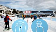 Skiers pass the restriction signs to line up at the chairlift at Les Portes du Soleil ski resort during the global outbreak of the coronavirus disease (COVID-19), in Les Crosets, Switzerland, December 19, 2020. REUTERS/Denis Balibouse/File Photo