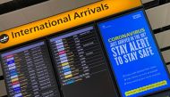 FILE PHOTO: A public health campaign message is displayed on an arrivals information board at Heathrow Airport, following the outbreak of the coronavirus disease (COVID-19), London, Britain, July 29, 2020. REUTERS/Toby Melville/File Photo
