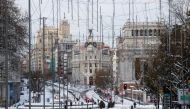 People walk in the snow, in downtown Madrid, Spain January 10, 2021. REUTERS/Susana Vera