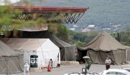 A health worker walks past tents erected at the parking lot of the Steve Biko Academic Hospital, amid a nationwide coronavirus disease (COVID-19) lockdown, in PRETORIA, South Africa, January 11, 2021. REUTERS/Siphiwe Sibeko
