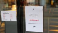 A note explaining the temporary closure by authorities due to COVID-19 measures is placed on the door of the Confiserie Spruengli restaurant, as the spread of the coronavirus disease continues, in Zurich, Switzerland January 11, 2021. REUTERS/Arnd Wiegman