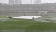 Water is seen pooling on the surface near the wicket during a rain delay on day two of the fourth test match between Australia and India at the Gabba in Brisbane, Australia, January 16, 2021. AAP Image/Darren England via Reuters 