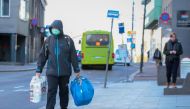 FILE PHOTO: A man wearing a protective mask carries shopping bags as he walks on the streets of Oslo following an outbreak of the coronavirus disease (COVID-19), in Oslo, Norway March 13, 2020. NTB Scanpix/Hakon Mosvold Larsen via REUTERS .
