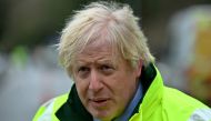 Britain's Prime Minister Boris Johnson talks to members of the media after being shown the Environment Agency's flood defence preparations during his visit to Withington in Manchester, as Storm Christoph brings heavy rains and flooding across the country,