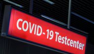 FILE PHOTO: A COVID-19 testing centre sign is pictured at Duesseldorf Airport in Duesseldorf, Germany, December 21, 2020. REUTERS/Wolfgang Rattay