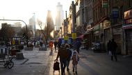 People walk past shops and market stalls, amid the coronavirus disease (COVID-19) outbreak, in east London, Britain, January 23, 2021. REUTERS/Henry Nicholls