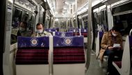 People wearing protective face masks ride the metro in a rush hour in Paris as France softens its strict lockdown rules during the outbreak of the coronavirus disease (COVID-19) in France, May 11, 2020. REUTERS/Benoit Tessier/File Photo