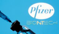 FILE PHOTO: A vial and sryinge are seen in front of a displayed Pfizer and Biontech logo in this illustration taken January 11, 2021. REUTERS/Dado Ruvic/Illustration/File Photo
