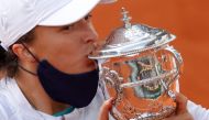 October 10, 2020. Poland's Iga Swiatek kisses the trophy as she celebrates after winning the French Open. REUTERS/Christian Hartmann/File Photo
