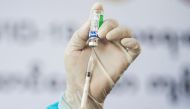 A medic inserts a syringe into a vial of AstraZeneca's COVISHIELD coronavirus disease (COVID-19) vaccine in Yangon, Myanmar, after the country received 1.5 million doses of the vaccine manufactured by the Serum Institute of India, January 27, 2021. REUTER
