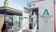 A healthcare worker gestures to a woman to be tested for the coronavirus disease (COVID-19) during massive testing in a mobile laboratory truck in Ronda, southern Spain January 29, 2021. REUTERS/Jon Nazca