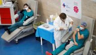 A health care worker receives the second dose of the Pfizer-BioNTech coronavirus disease (COVID-19) vaccine at a vaccination centre in Rome, Italy, January 27, 2021. REUTERS/Yara Nardi