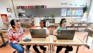 Pupils sitting behind partition boards made of plexiglass attend a class at a primary school, during the coronavirus disease (COVID-19) outbreak, in Den Bosch, Netherlands, May 8, 2020. REUTERS/Piroschka van de Wouw/File Photo