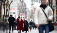 FILE PHOTO: People with protective masks walk down a shopping street during the second lockdown as the coronavirus disease (COVID-19) outbreak continues in Vienna, Austria, November 13, 2020. REUTERS/Lisi Niesner
