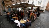 People sit at a restaurant in Trastevere after the coronavirus disease (COVID-19) restrictions were eased in Lazio region, Rome, Italy, February 1, 2021. REUTERS/Guglielmo Mangiapane
