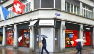 People walk past a Swatch store, which is closed during a partial lockdown as the spread of the coronavirus disease (COVID-19) continues, in Zurich, Switzerland January 28, 2021. REUTERS/Arnd Wiegmann

