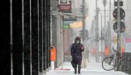 A person walks on a street during a snowfall in Berlin, Germany, February 7, 2021. REUTERS/Hannibal Hanschke