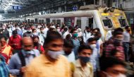 Commuters walk on a railway platform after disembarking from a train amidst the spread of the coronavirus disease (COVID-19) in Mumbai, India, February 9, 2021. REUTERS/Francis Mascarenhas