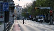 FILE PHOTO: A man crossing a street as Croatia is stepping up measures to fight the coronavirus disease (COVID-19) outbreak, in Zagreb, Croatia March 21, 2020. REUTERS/Antonio Bronic
