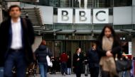 FILE PHOTO: Pedestrians walk past a BBC logo at Broadcasting House in London, Britain January 29, 2020. REUTERS/Henry Nicholls/File Photo
