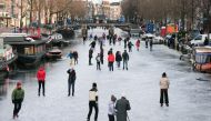 People ice skate during a cold snap across the country at the Prinsengracht in Amsterdam, Netherlands February 14, 2021. Reuters/Eva Plevier