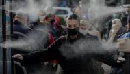 FILE PHOTO. People are disinfected before entering a market, as Albanian authorities take measures to stop the spread of the coronavirus disease (COVID-19), in Tirana, Albania April 6, 2020. REUTERS/Florion Goga