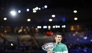 Tennis - Australian Open - Men's Singles Final - Melbourne Park, Melbourne, Australia, February 21, 2021 Serbia's Novak Djokovic celebrates with the trophy after winning his final match against Russia's Daniil Medvedev REUTERS/Asanka Brendon Ratnayake
