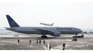 FILE PHOTO: A United Airlines Boeing 777-200ER plane is towed as an American Airlines Boeing 737 plane departs from O'Hare International Airport in Chicago, Illinois, U.S. Nov. 30, 2018. REUTERS/Kamil Krzaczynski/File Photo
