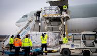 Workers unload a shipment of Chinese company Sinopharm's coronavirus disease (COVID-19) vaccine as it arrives at Budapest Airport, Hungary, February 16, 2021. Ministry of Foreign Affairs and Trade (KKM)/Handout via Reuters