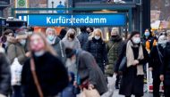 FILE PHOTO: People with protective face masks walk at Kurfurstendamm shopping boulevard, amid the coronavirus disease (COVID-19) outbreak in Berlin, Germany, December 5, 2020. REUTERS/Fabrizio Bensch/File Photo