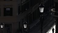 A person walks along Via dei Condotti amid the coronavirus disease (COVID-19) outbreak in Rome, Italy, February 26, 2021. REUTERS/Yara Nardi
