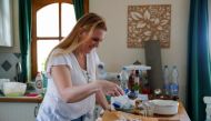 Eszter Harmath prepares a cake at home during the coronavirus disease (COVID-19) pandemic, in Szentendre, Hungary, February 26, 2021. Picture taken February 26, 2021. Reuters/Bernadett Szabo
