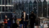People wearing protective masks amid the outbreak of coronavirus disease (COVID-19) walk in the centre of Warsaw, Poland February 24, 2021. REUTERS/Kacper Pempel/File Photo