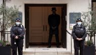Police officers and a doorman stand outside King Edward VII's Hospital, where Britain's Prince Philip was admitted, in London, Britain March 5, 2021. REUTERS/John Sibley